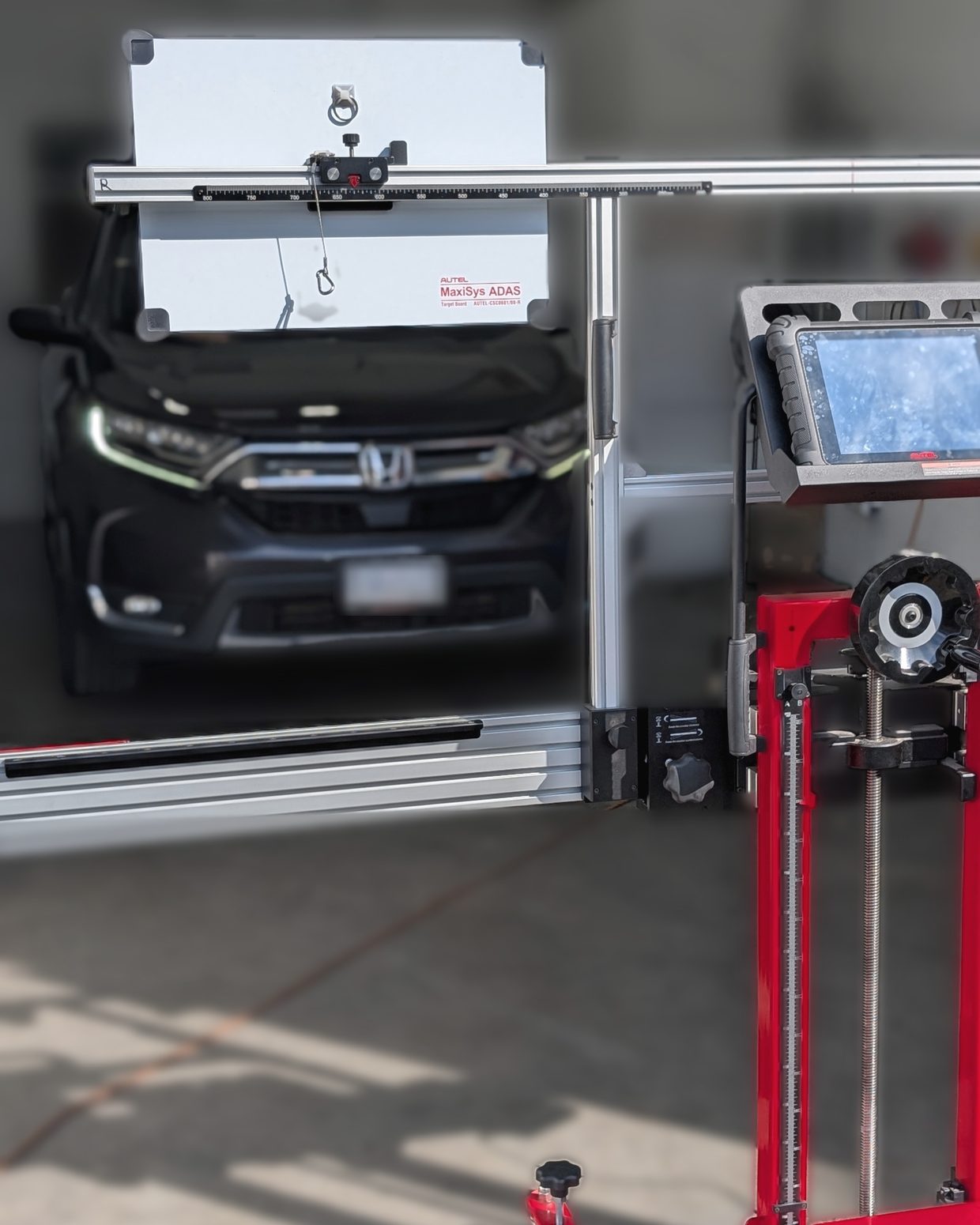 Autel MaxiSys ADAS calibration frame and target board set up in front of a Honda CR-V for a static camera calibration